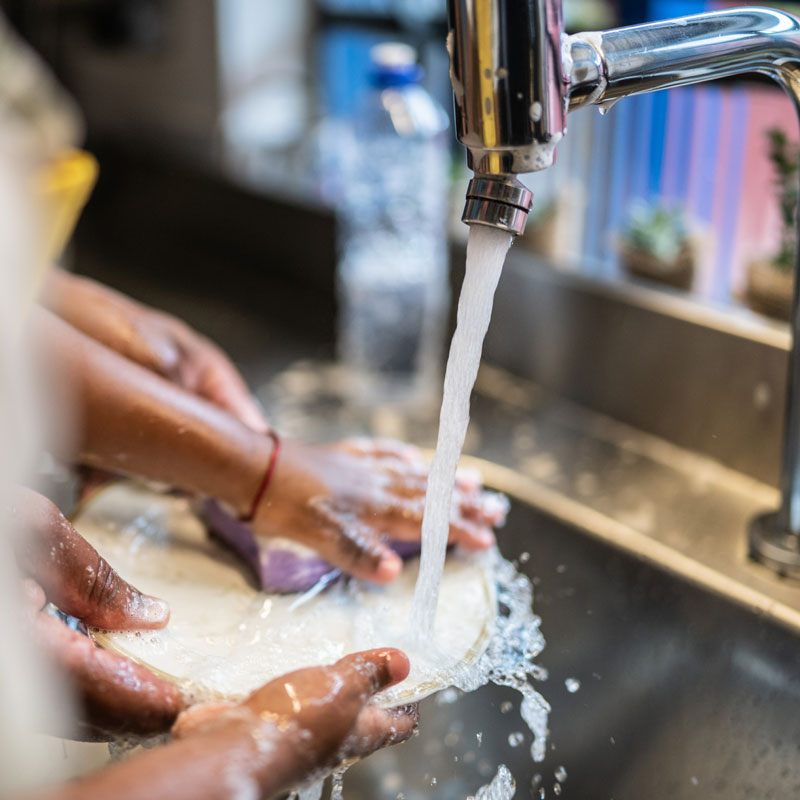 Person washing dishes.