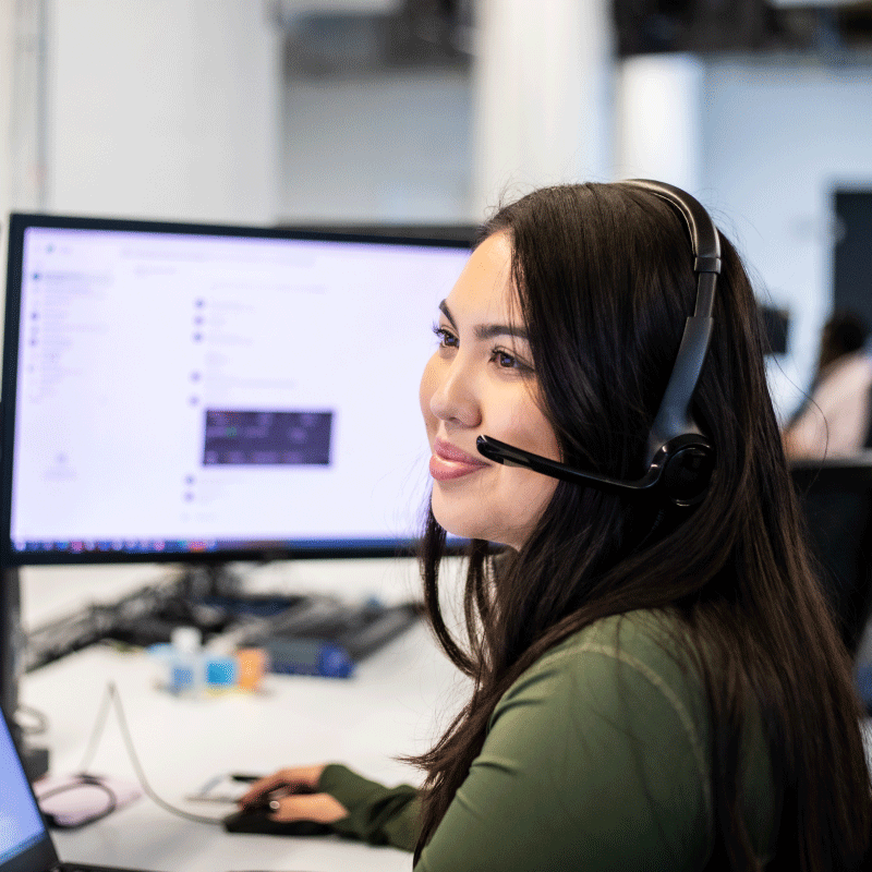 An Echo representative answering client calls with their headset while sitting at their computer.