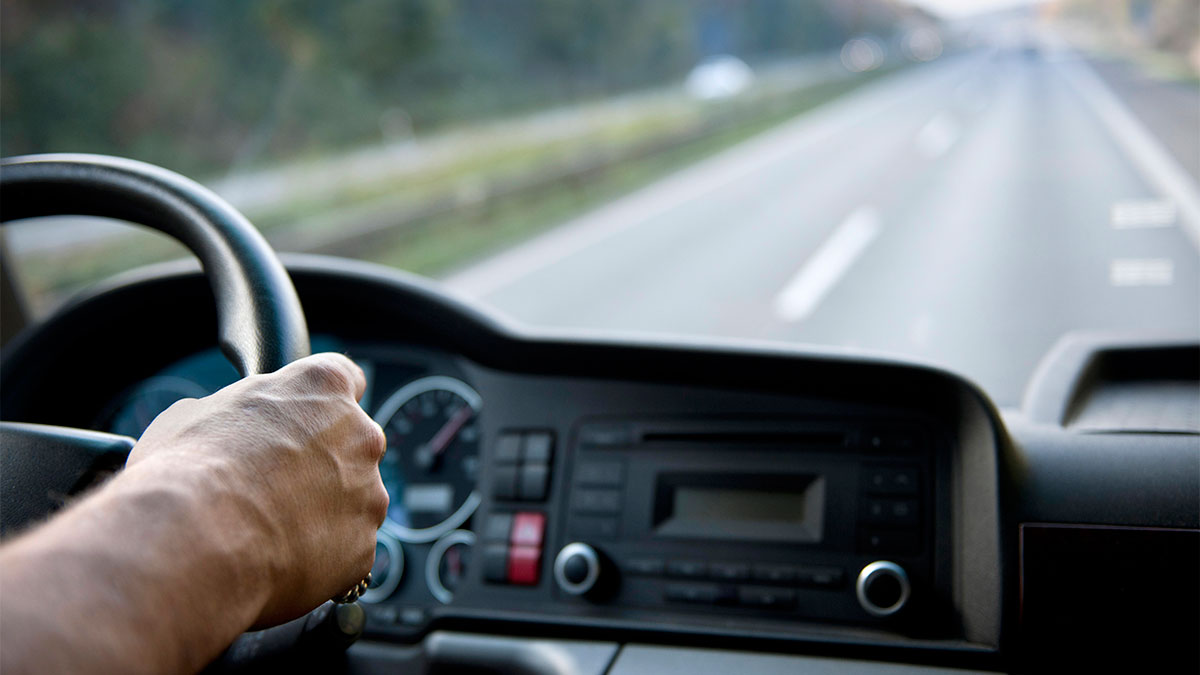 view of open highway from a driver's perspective, looking through the windshield of a semi truck