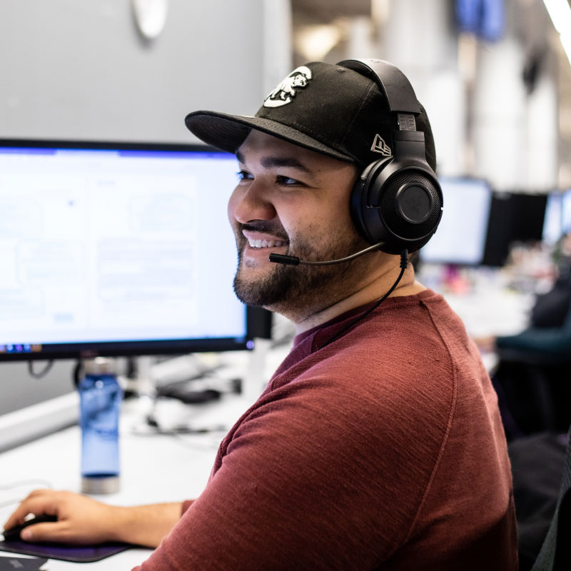 An Echo representative answering client calls on their headset while sitting at their desk.