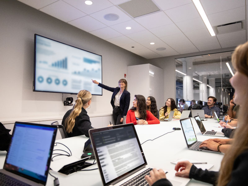 Echo employees in a conference room watching and listening to a presentation.