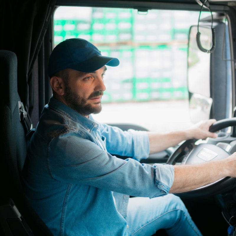 Carrier sitting in drivers seat of truck.