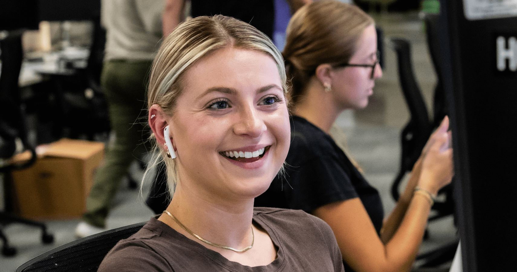 An Echo employee smiling while working at their computer.