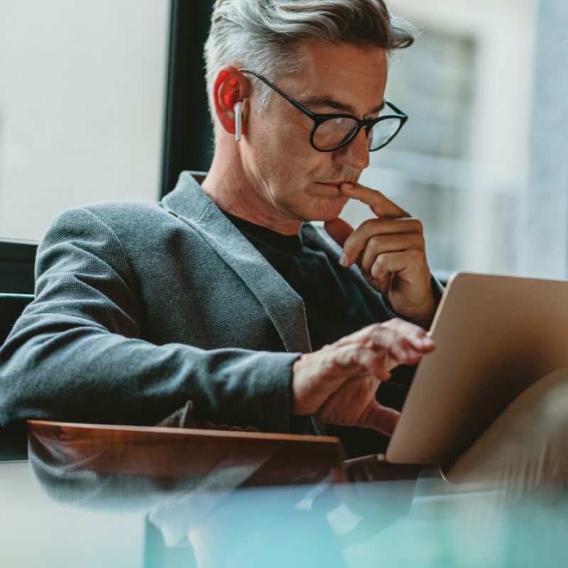 A client on their laptop in a business setting looking at their recent shipments.