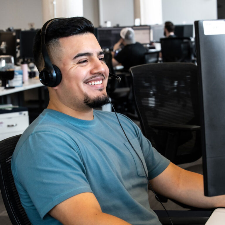 A Echo employee smiling while working at desk in the office.