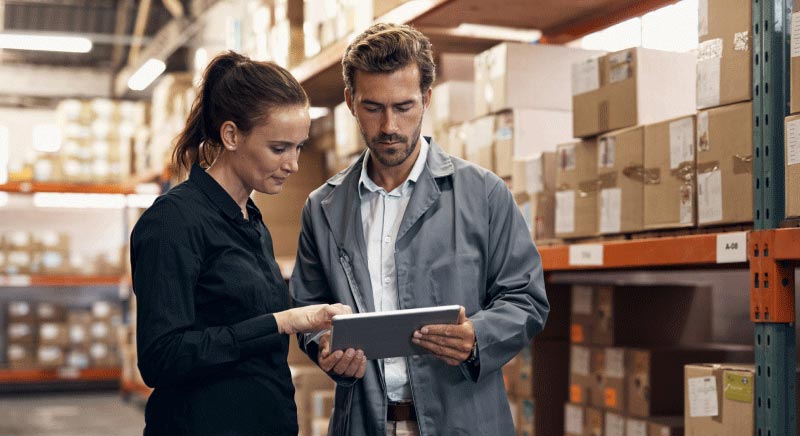 Man and Woman looking at tablet in warehouse