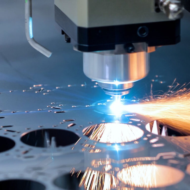 A laser cutting through metal in an industrial plant.