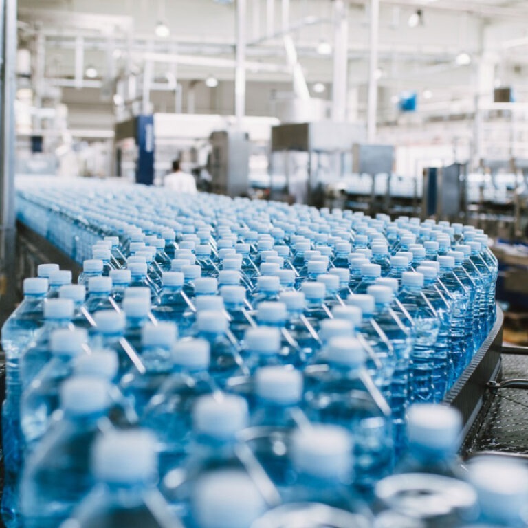 Water bottles on a conveyor belt in a factory.