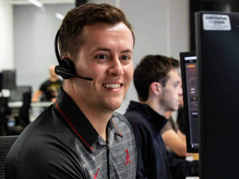 An Echo employee sitting at his desk on the phone with a client.