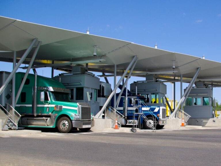 Multiple semi trucks at the Canadian and USA border for Canadian customs for cross border shipping.