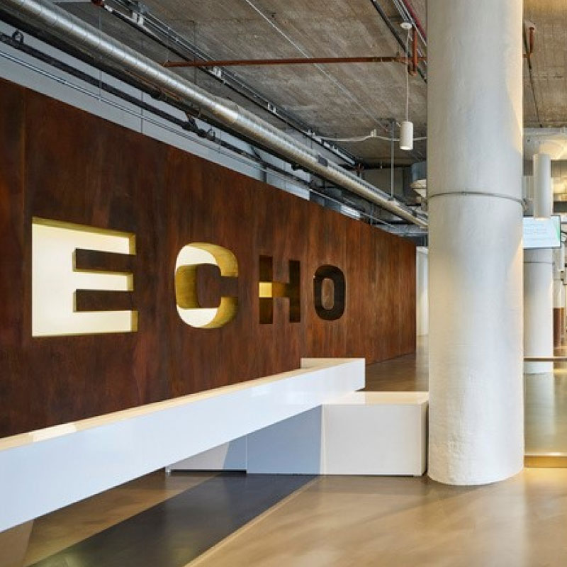 Echo's Chicago Headquarter's entryway featuring a brown Echo logo wall.