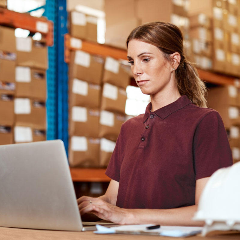 An intermodal shipper on a computer inside a warehouse.