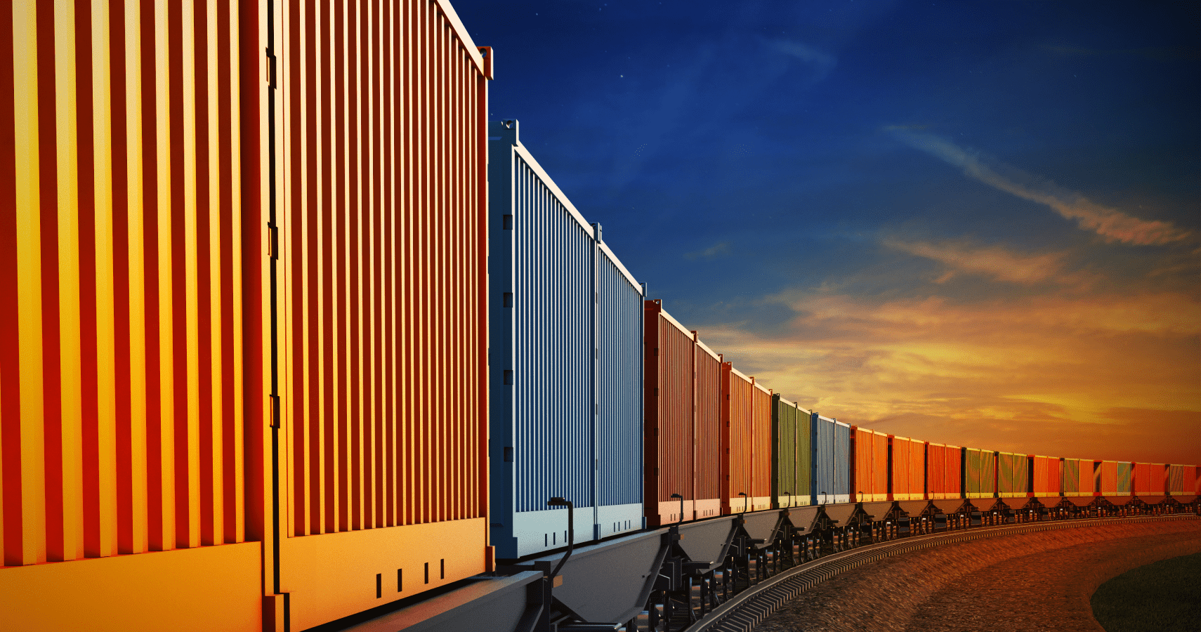 An intermodal rail car carrying brightly colored freight during a sunset.