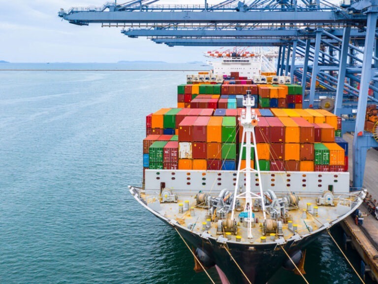 Freight containers packed on a cargo ship docked at a shipping port.