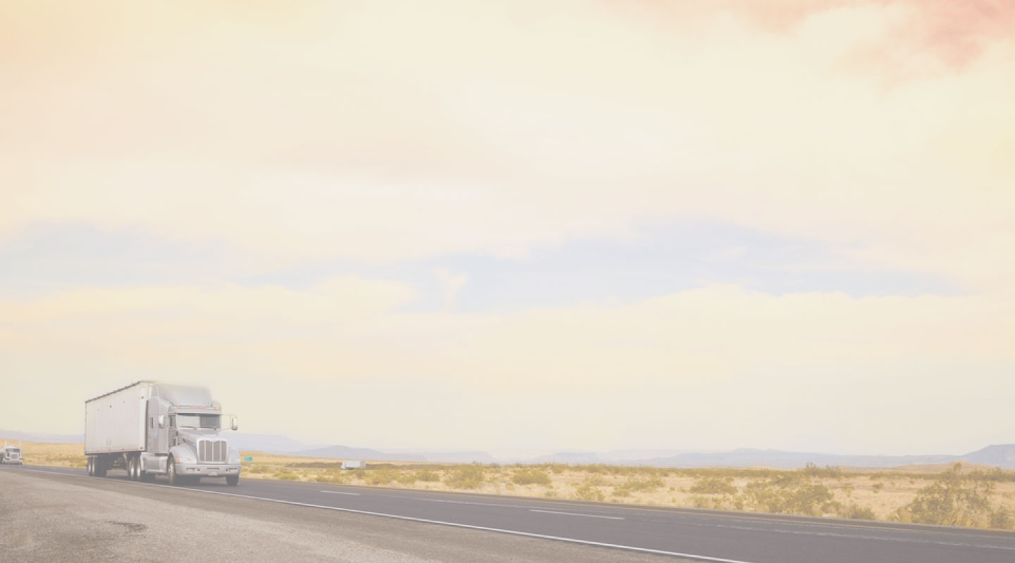 A white truck driving down the highway in California.