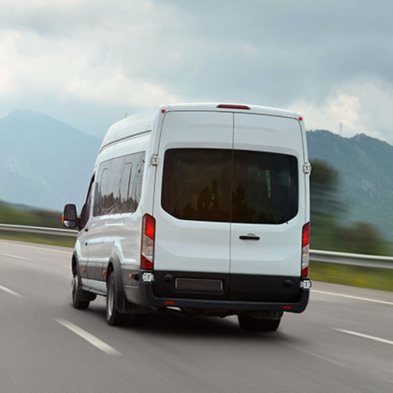 A van driving on the highway during the evening time.