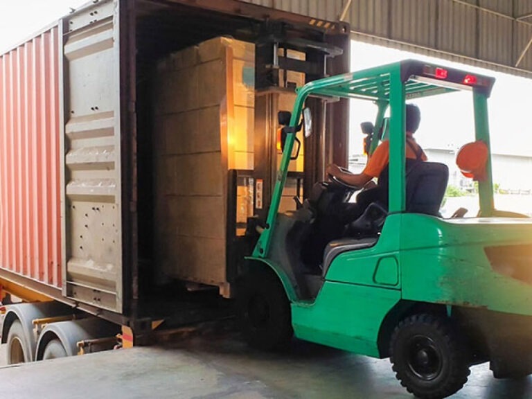 A packaged shipment being loaded onto the truck for delivery.