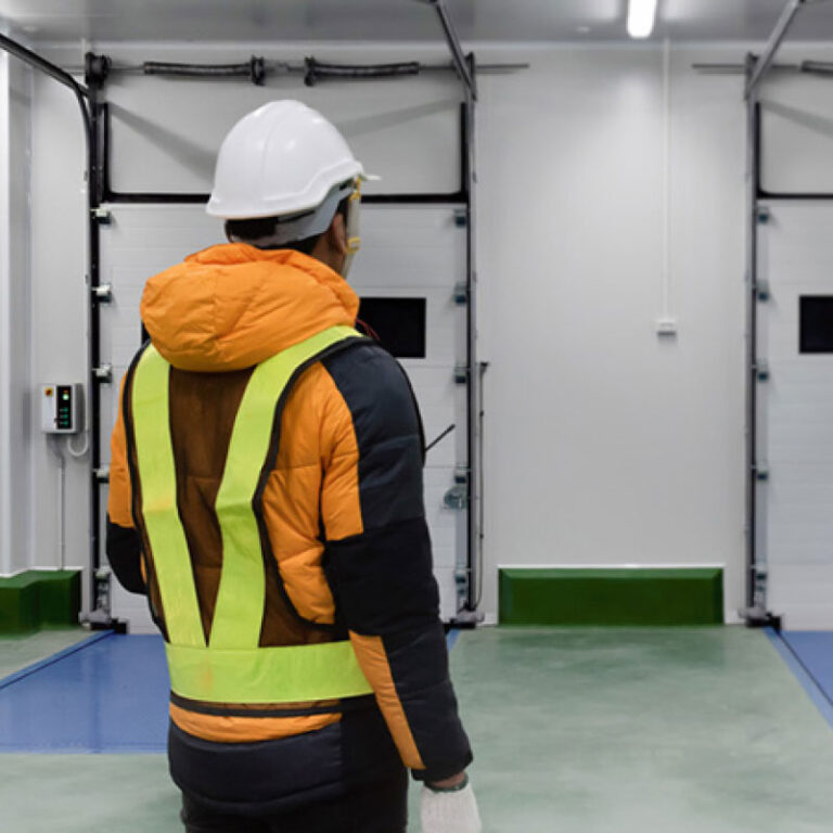 Two temperature-controlled shipping experts at a warehouse loading dock.