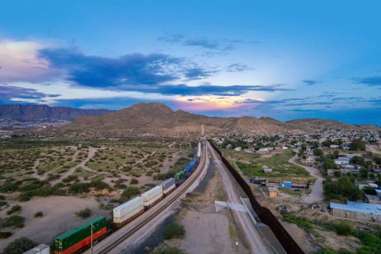 Freight train driving along train tracks in Mexico.