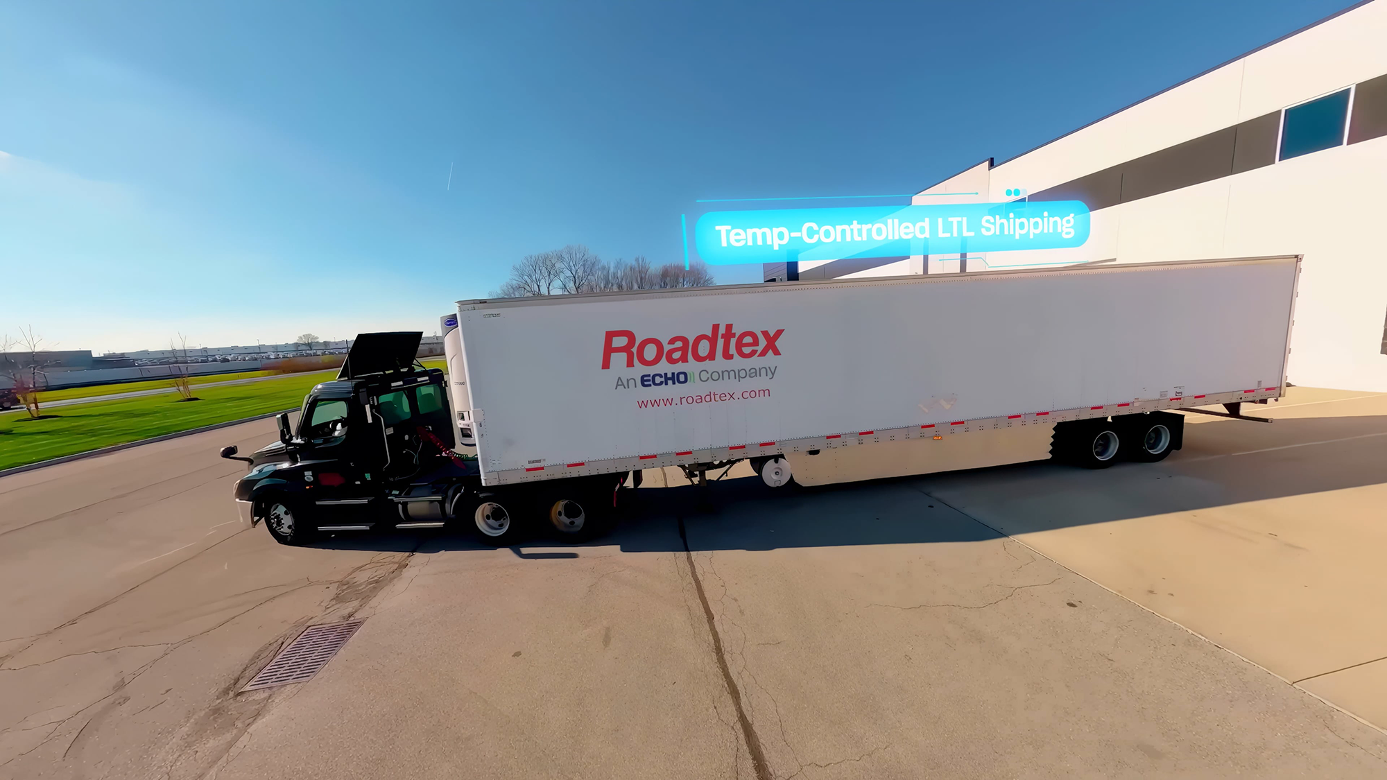 Roadtex branded semi truck backing up to warehouse facility