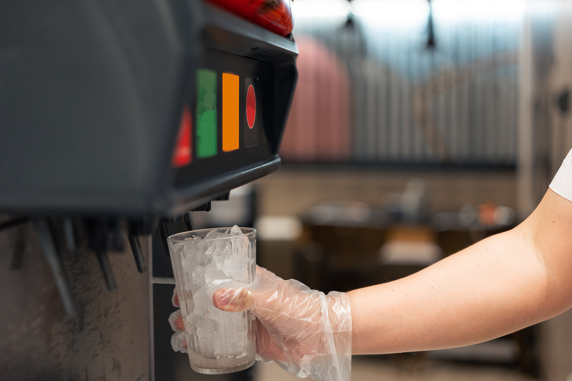 A cup being filled with ice from an ice machine.