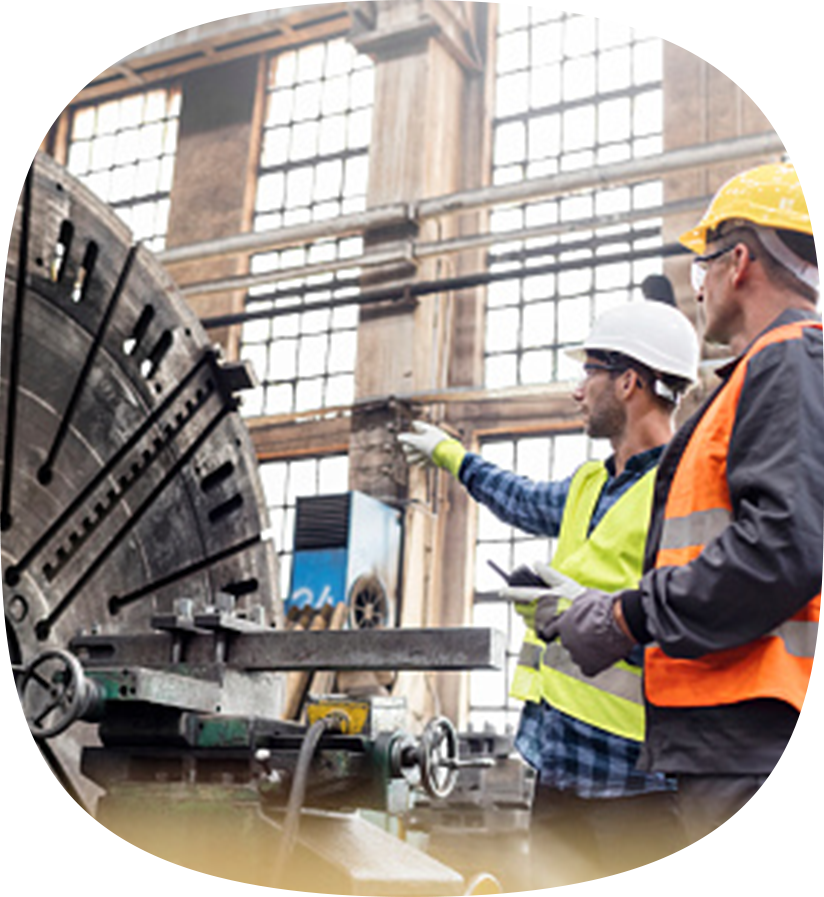 Two people looking at an industrial piece of equipment.